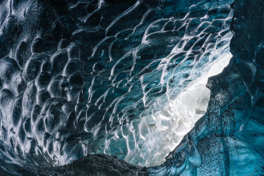 The scalloped blue ice ceiling of a glacier ice cave in Iceland