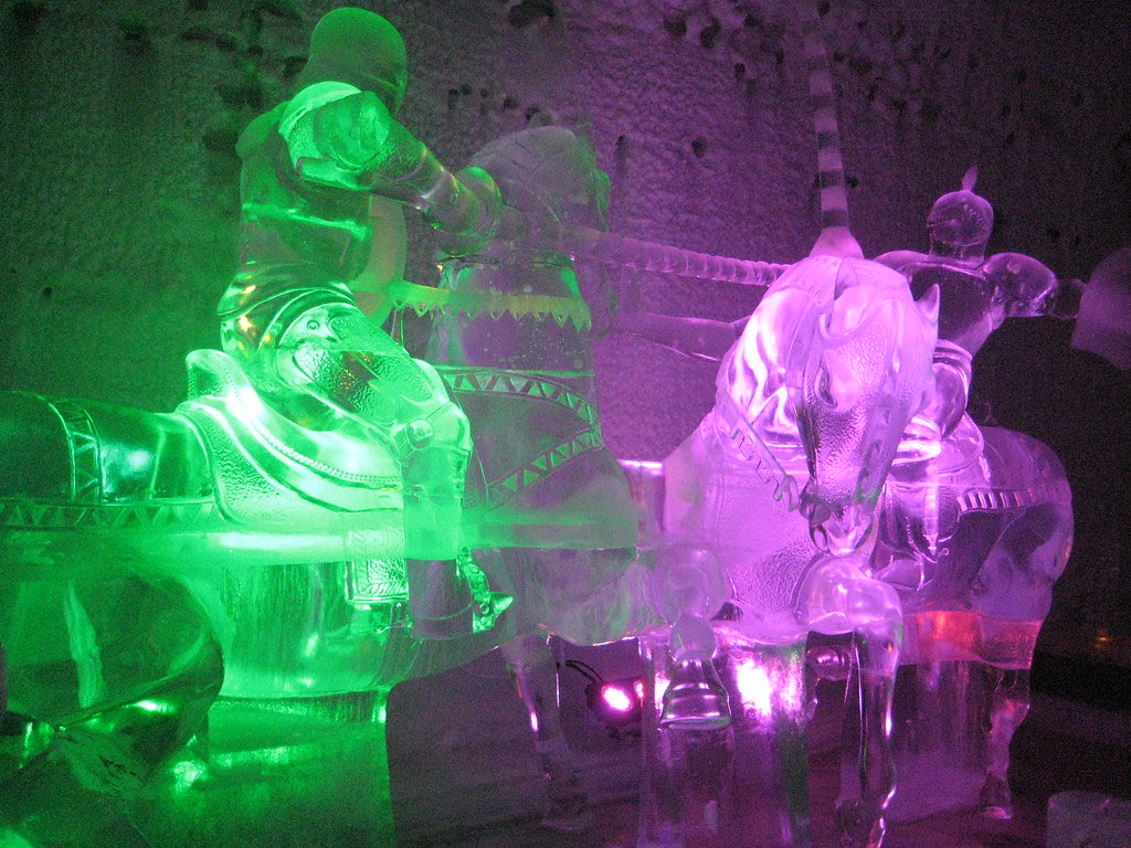 Ice sculptures of jousting knights on horseback lit green and violet inside the Aurora Ice Museum at Chena Hot Springs